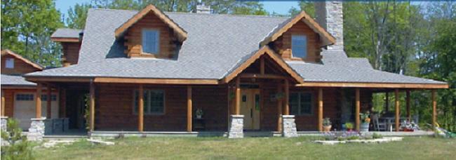 Log cabin in an open forest with a stone chimney